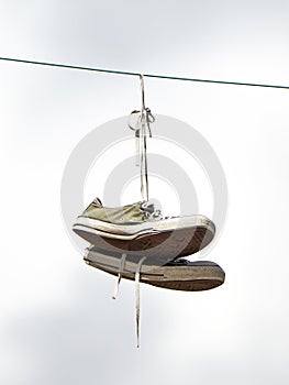 Old sneakers hanging from a powerwire