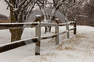 old snow-covered fence