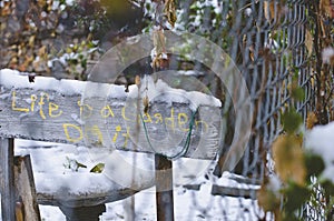 The old snow covered garden sign