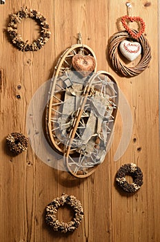 Old Snow Rackets on Wood Wall with Wreaths and Garlands in a Mountain Cabin