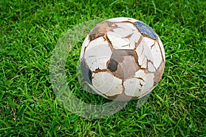 .Old soccer ball on fresh spring green grass