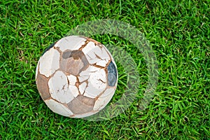 .Old soccer ball on fresh spring green grass