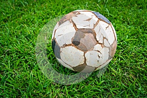 .Old soccer ball on fresh spring green grass