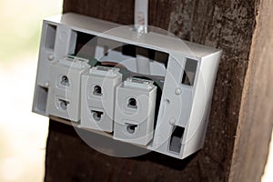 An old socket on an old wooden pole