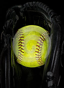 Old softball in a glove