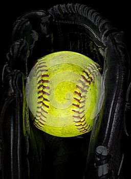 Old softball in a glove