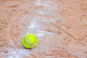 Old Softball in a softball field in California mountains on a white line