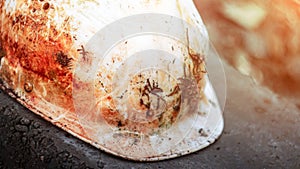 An old soiled white plastic safety helmet
