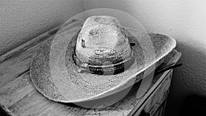 An old sombreo sitting on a wooden table photo