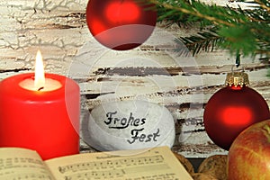 Old songbook, christmas decoration and candle photo