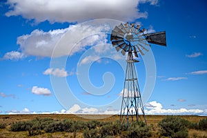 Old southwestern farm windmill somewhere in the desert in California, USA