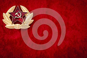 Old Soviet badge with the red star, laurel wreath, a sickle and a hammer reminiscent of the cold war era worn by the soldiers of