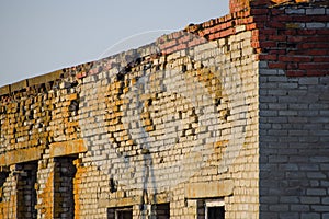 Old soviet brick abandoned building. Collapsing brick construction