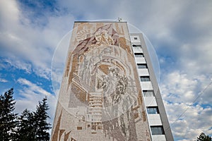 Old soviet building with a mosaic, an old communist fresco with socialist propaganda