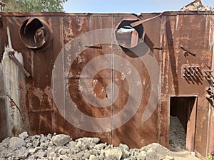 Old Soviet bunker. Rusty walls and gray concrete stones.