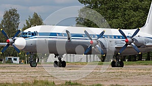 Old soviet civil propeller airliner. Russian turboprop old aircraft parking at the airport. Aviation, air Force