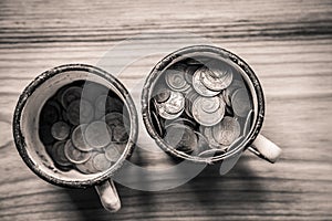 Old soviet coins in a rusty enamel cup - monochrome vintage look