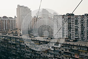 Old soviet economy class buildings. City center at the background