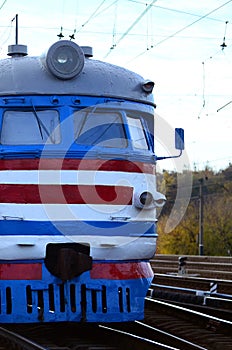 Old soviet electric train with outdated design moving by rail