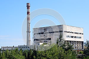 old Soviet factory with a pipe. Abandoned Soviet industry