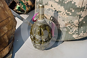 Old soviet hand grenade F1 against the background of camouflage