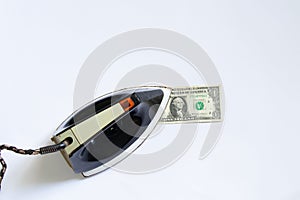 Old soviet iron stroking one dollar on a white background