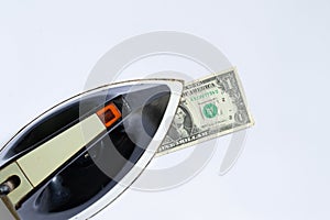 Old soviet iron stroking one dollar on a white background