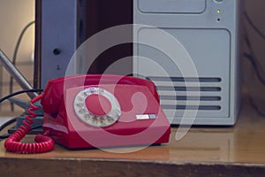 An old Soviet red telephone with a dial dial