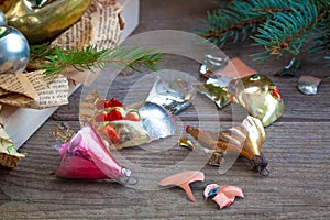 Old Soviet Russian Christmas New year glass toys on the wooden background with broken pieces