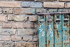 Old Soviet-style mailboxes. Old metal and numbered mailboxes on brick wall