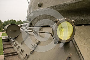 The old Soviet tank T-34-85 with headlights on