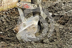 An old Soviet tractor digs and loads waste stone processing