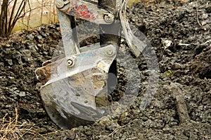 An old Soviet tractor digs and loads waste stone processing