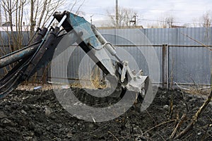 An old Soviet tractor digs and loads waste stone processing