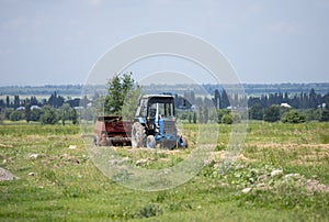 An old soviet tractor working in a field in Kyrgyzstan