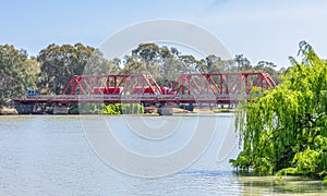 An old span bridge over the Murray River with heavy trucks crossing. photo
