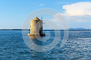 Old Spanish windmill in lagoon Orbetello on peninsula Argentario. Italy