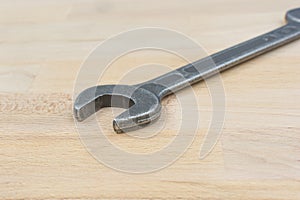 Old spanner on a wooden table