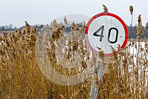 Old speed limit sign on the side of the road