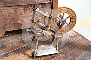 Old spinning wheel. Vintage tailoring equipment concept.