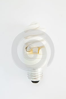 Old spiral light bulb on a white background