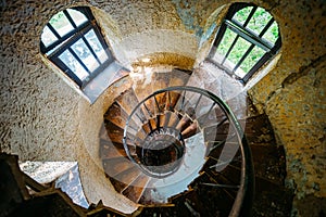 Old spiral staircase in abandoned mansion, upside view