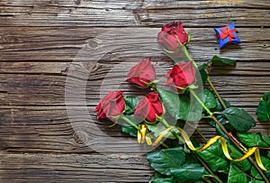 Old splintered wood background with stemmed roses