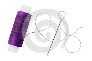 Old spool of thread and needle on a white background. Sewing accessories