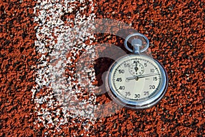 Old sport stopwatch on running track rubber