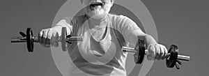 Old sportman lifting dumbbells. Elderly man workout.