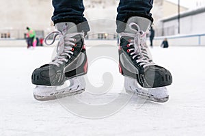 Old sports hockey skates. on a man`s leg. on the ice.