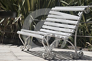 old square bench made of wood painted white