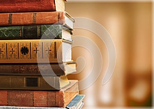 Old stacked books on blurred background