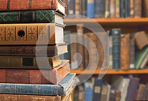 Old stacked books on dark background